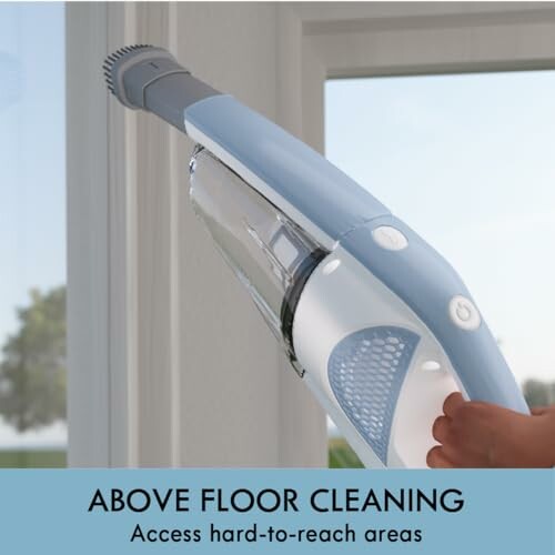 Handheld vacuum cleaning window corner.