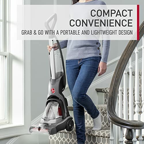 Person carrying a compact vacuum cleaner up stairs