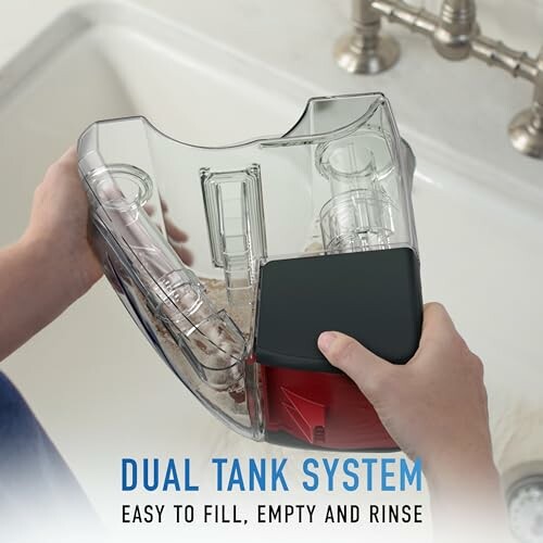 Hands holding a dual tank system for easy fill, empty, and rinse.